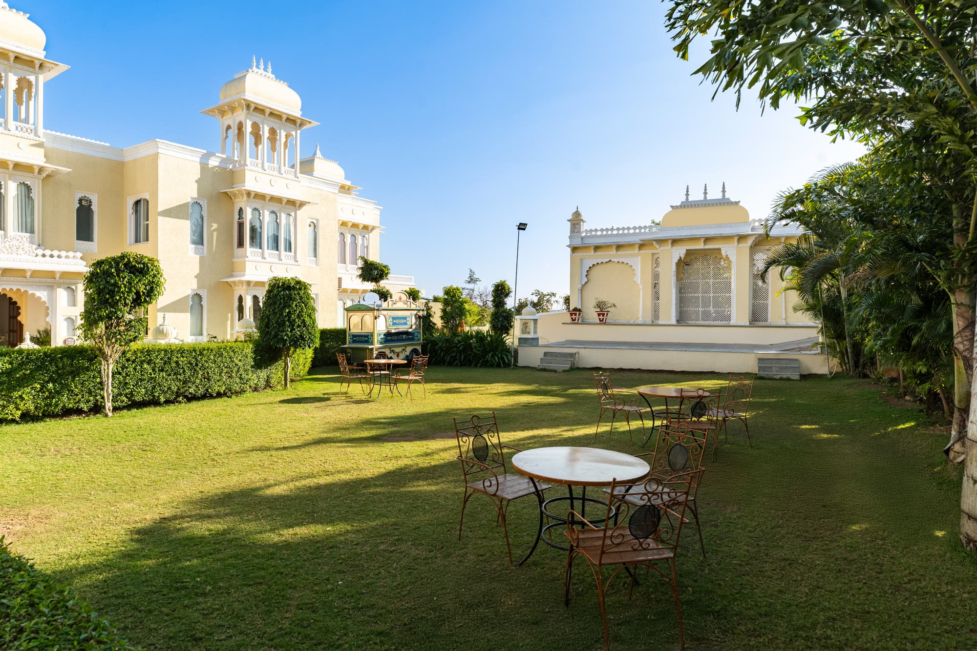 The garden lawn with outdoor seating, next to the resort building