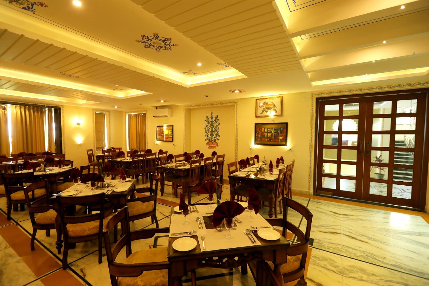 The resort restaurant, a dining hall with laid tables